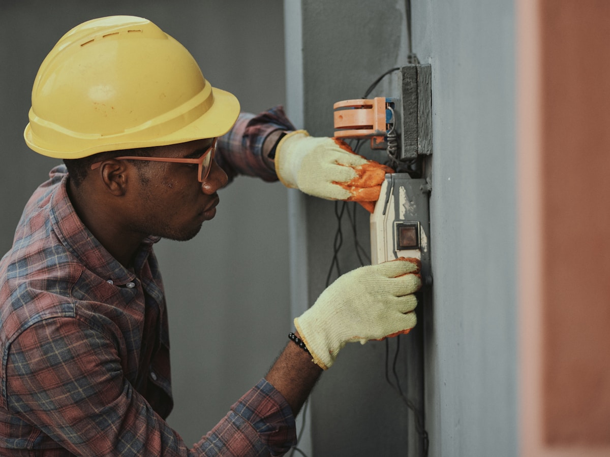 Technician installing CCTV cabling inside a residential utility space